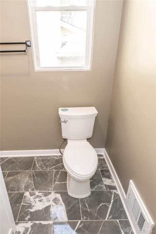 bathroom with visible vents, marble finish floor, baseboards, and toilet