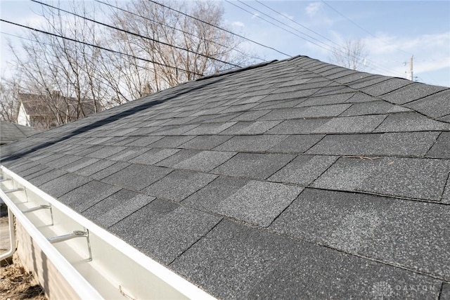 exterior details with roof with shingles