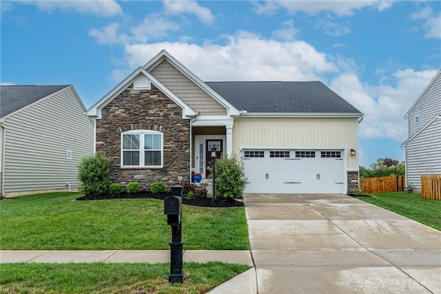 craftsman house featuring fence, a front yard, stone siding, concrete driveway, and an attached garage