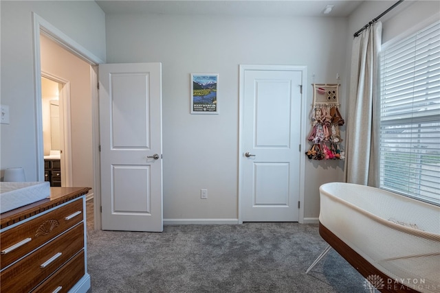 bedroom with baseboards, multiple windows, and dark carpet