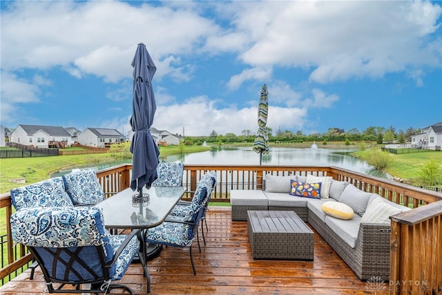 wooden deck with a water view, an outdoor living space, and outdoor dining space