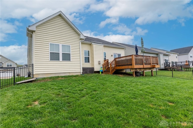 back of house with a lawn, a wooden deck, and a fenced backyard