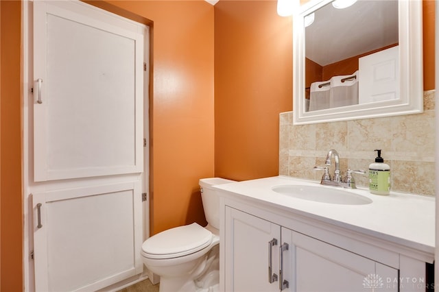 bathroom with toilet, tasteful backsplash, and vanity