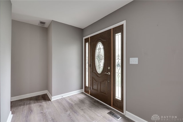 foyer with visible vents, plenty of natural light, and wood finished floors