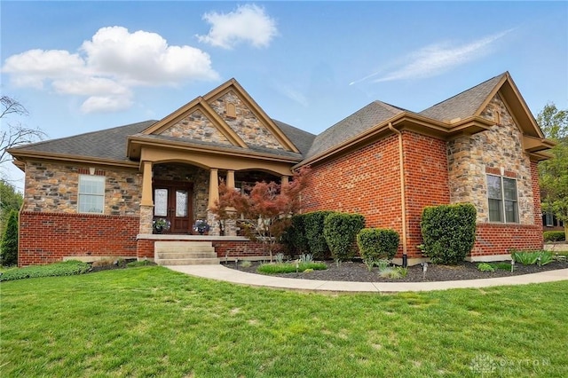 view of front of property with covered porch, brick siding, stone siding, and a front lawn