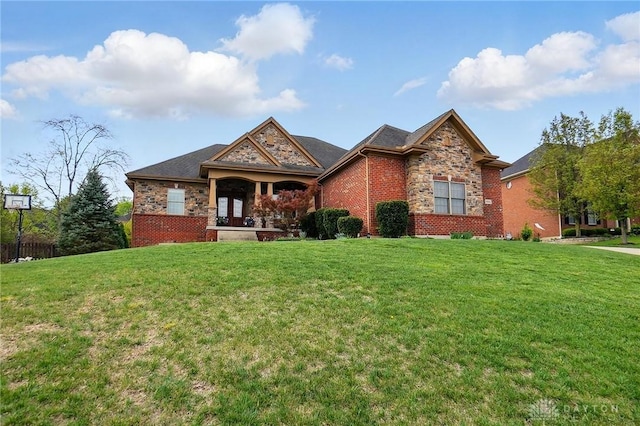 craftsman-style house featuring a front lawn, french doors, and stone siding