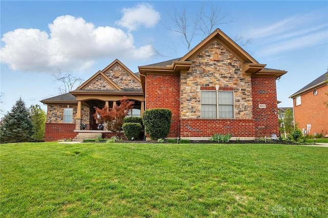 view of front of property with a front yard and stone siding
