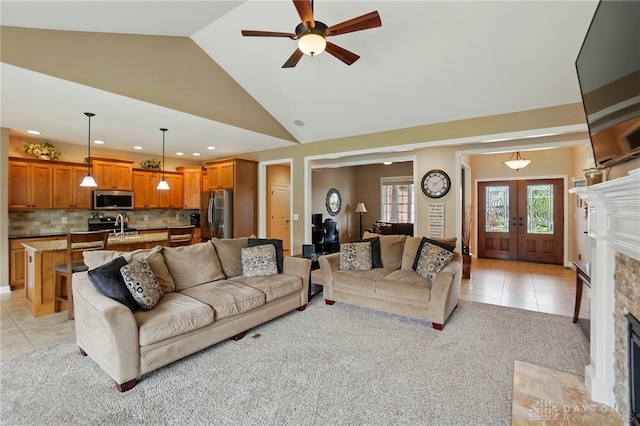 living room featuring light tile patterned flooring, ceiling fan, light colored carpet, recessed lighting, and a fireplace with flush hearth