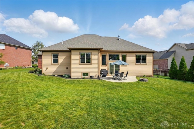 rear view of property featuring a yard, fence, and a patio area