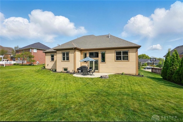 rear view of property with a lawn and a patio