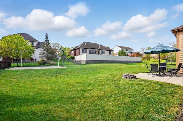 view of yard with fence, a patio, an outdoor fire pit, and a residential view