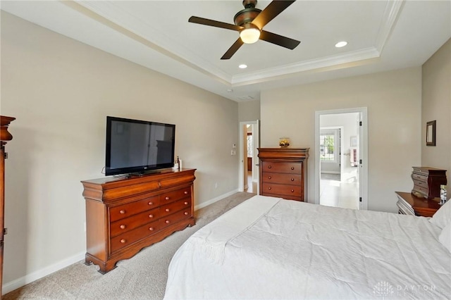 carpeted bedroom featuring recessed lighting, ornamental molding, a raised ceiling, and baseboards