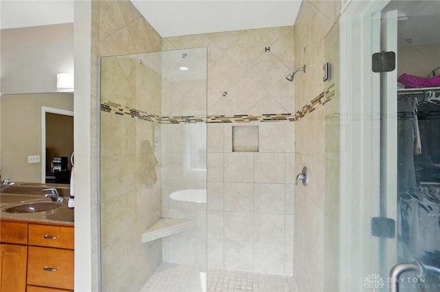 bathroom featuring a shower stall and vanity