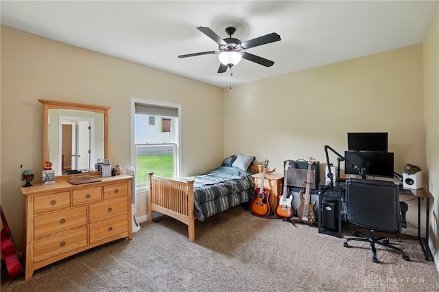 bedroom featuring ceiling fan and carpet