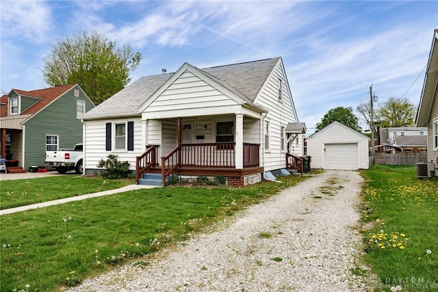 bungalow-style house featuring an outdoor structure, a garage, a front lawn, gravel driveway, and a porch