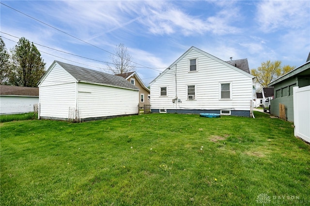 rear view of property featuring a lawn