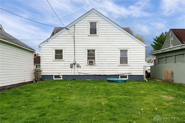 rear view of house with a yard
