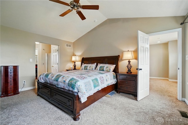 bedroom with carpet floors, visible vents, and vaulted ceiling