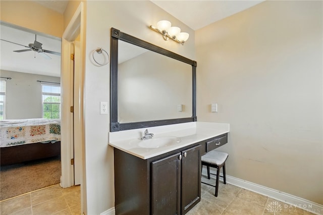 ensuite bathroom with ensuite bath, vanity, tile patterned floors, a ceiling fan, and baseboards