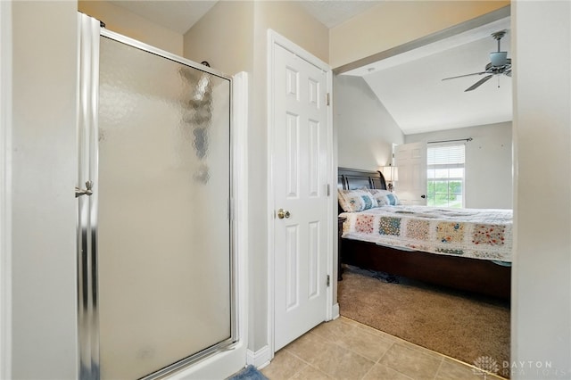 ensuite bathroom with a stall shower, ceiling fan, vaulted ceiling, and ensuite bath