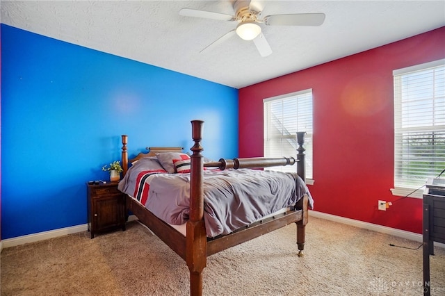carpeted bedroom with a textured ceiling, ceiling fan, and baseboards