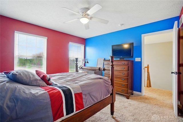 carpeted bedroom with a textured ceiling and ceiling fan