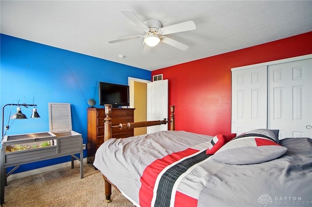 carpeted bedroom with baseboards, a ceiling fan, a closet, and visible vents