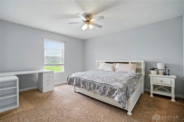 bedroom featuring carpet floors, baseboards, and a textured ceiling