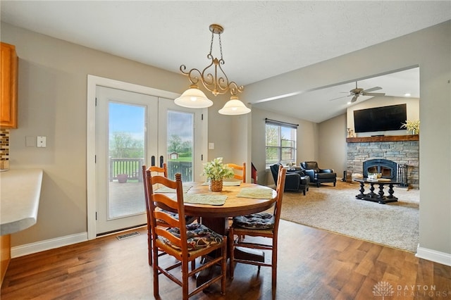 dining space featuring visible vents, ceiling fan, wood finished floors, and french doors