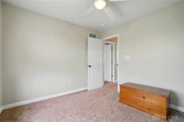 unfurnished bedroom with a ceiling fan, baseboards, visible vents, and carpet