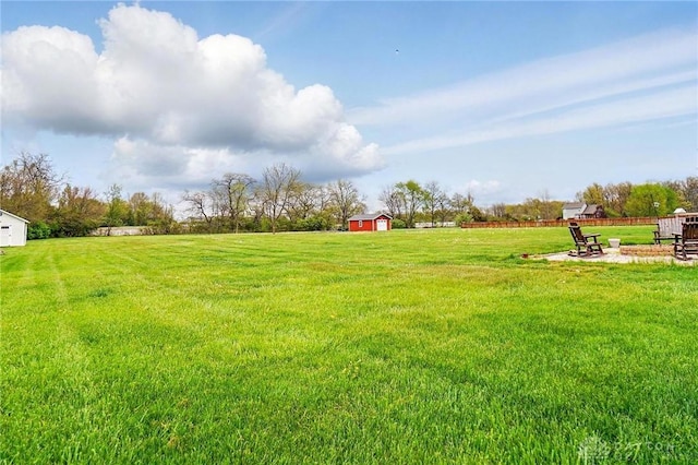 view of yard with a storage shed and an outbuilding
