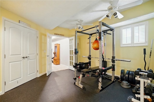 workout area featuring ceiling fan and baseboards
