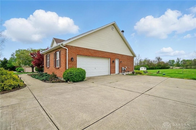 view of property exterior featuring a garage, a lawn, concrete driveway, and brick siding