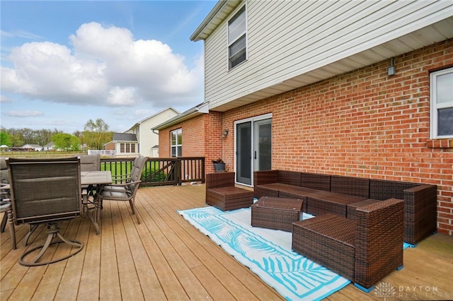 wooden terrace featuring outdoor dining area and an outdoor hangout area