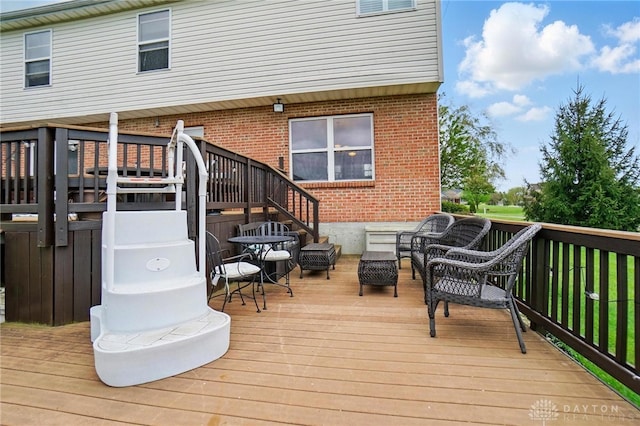 wooden deck featuring outdoor lounge area and stairs