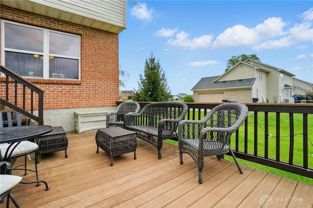 wooden deck with a lawn and an outdoor hangout area