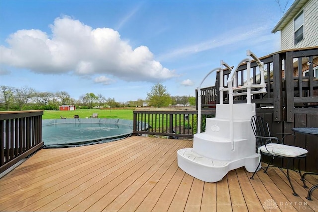 wooden terrace featuring a lawn, a playground, and a covered pool