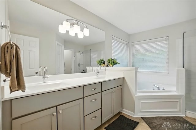 5497 Riverwalk Dr, Kings Mills, OH 45034 - full bathroom with a shower stall, double vanity, a garden tub, and tile patterned flooring
