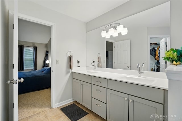 5497 Riverwalk Dr, Kings Mills, OH 45034 - ensuite bathroom with double vanity, a walk in closet, tile patterned flooring, and a chandelier