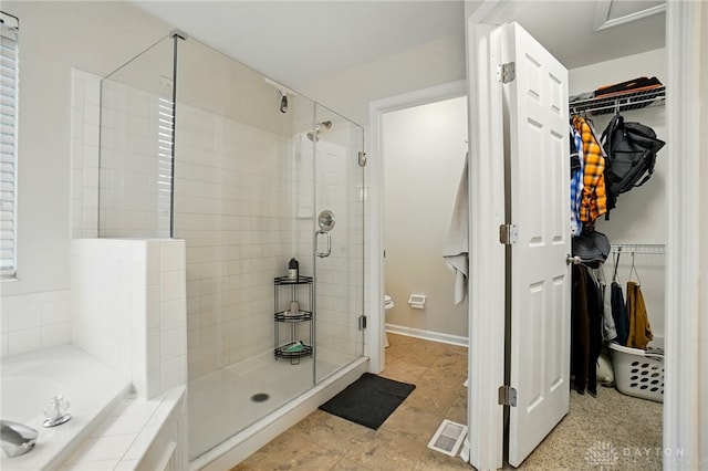 5497 Riverwalk Dr, Kings Mills, OH 45034 - full bathroom with a shower stall, a garden tub, a walk in closet, and toilet