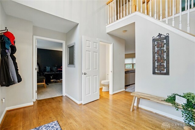 5497 Riverwalk Dr, Kings Mills, OH 45034 - foyer entrance with light wood-style floors, baseboards, and a high ceiling