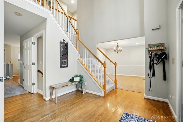 5497 Riverwalk Dr, Kings Mills, OH 45034 - stairs with wood finished floors, baseboards, a high ceiling, a chandelier, and recessed lighting