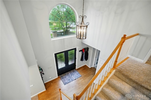 5497 Riverwalk Dr, Kings Mills, OH 45034 - foyer featuring a chandelier, french doors, wood finished floors, stairs, and baseboards