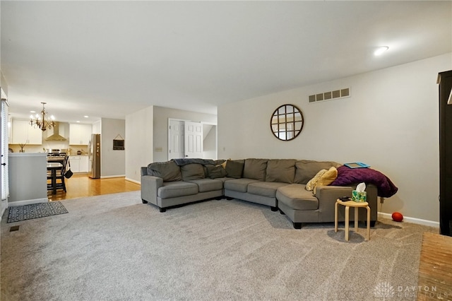 5497 Riverwalk Dr, Kings Mills, OH 45034 - living room with a chandelier, baseboards, light carpet, light wood finished floors, and recessed lighting