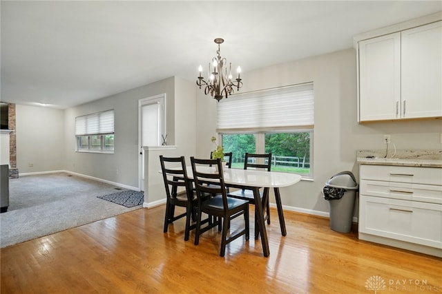 5497 Riverwalk Dr, Kings Mills, OH 45034 - dining area featuring a chandelier, light wood finished floors, baseboards, and a brick fireplace