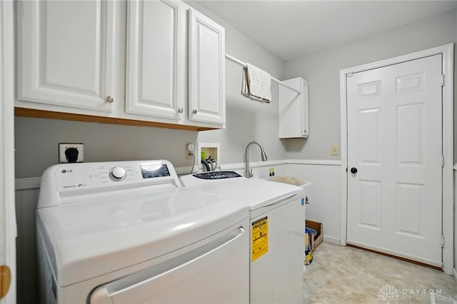 5497 Riverwalk Dr, Kings Mills, OH 45034 - clothes washing area with cabinet space, washing machine and clothes dryer, and wainscoting