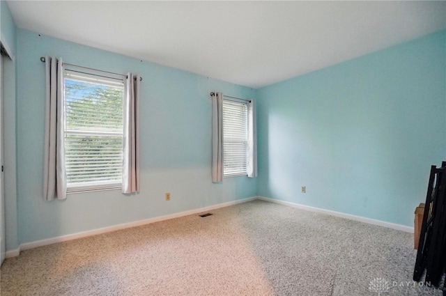 5497 Riverwalk Dr, Kings Mills, OH 45034 - spare room with healthy amount of natural light, baseboards, and carpet flooring