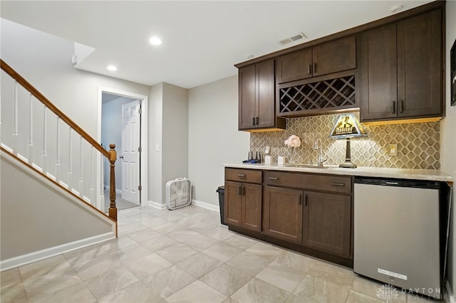 5497 Riverwalk Dr, Kings Mills, OH 45034 - indoor wet bar with dishwashing machine, tasteful backsplash, stairway, baseboards, and recessed lighting