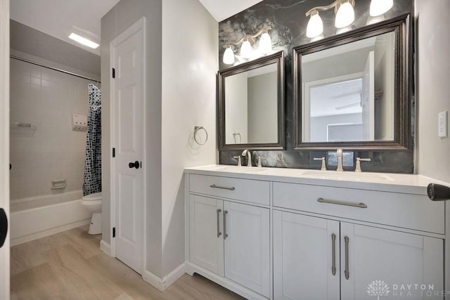 8464 Mcewen Rd, Washington Twp, OH 45458 - full bathroom with a sink, toilet, double vanity, and shower / tub combo