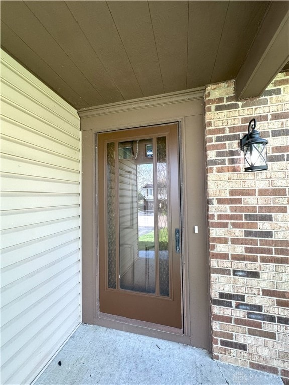 entrance to property with brick siding